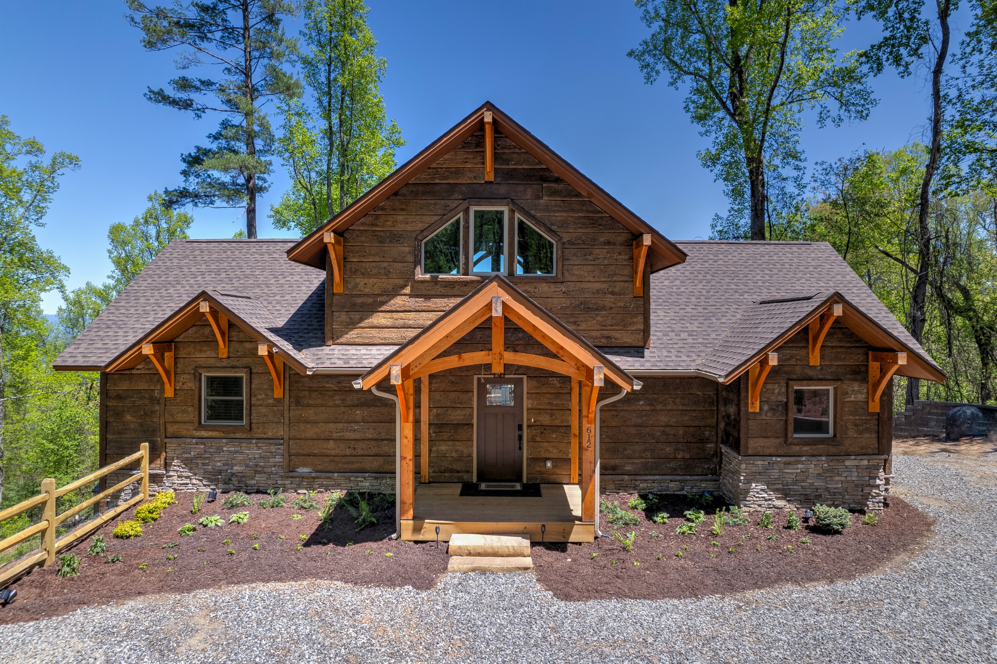 Timber-framed entrance to Elk Mountain Escape among mountain trees
