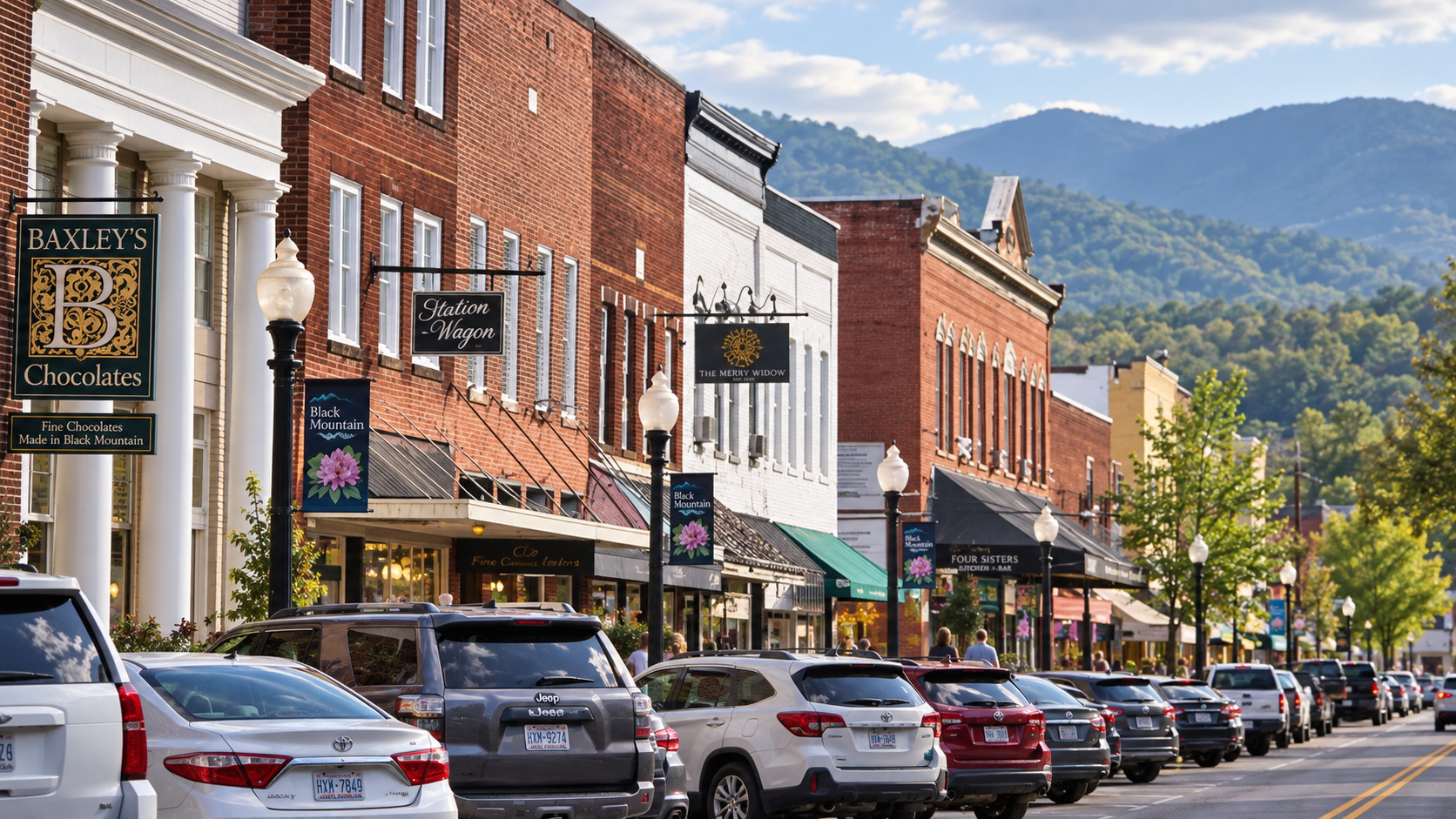 Downtown Black Mountain with shopfronts and mountains beneath a blue sky